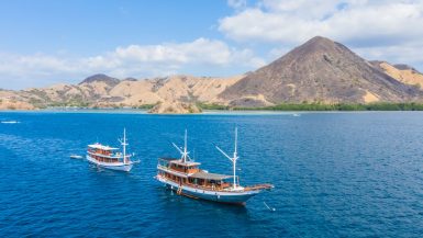 Liveaboard boats cruising through Komodo National Park waters