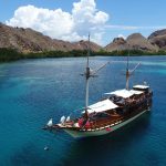 Traditional wooden phinisi boat in Komodo waters