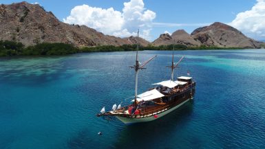Traditional wooden phinisi boat in Komodo waters